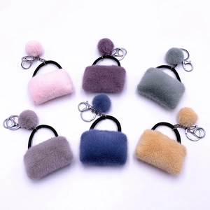 Plush handbag keychains with faux fur pom poms in six candy colors for bag accessories