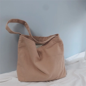 Detailed close-up of a camel canvas tote bag showing high-quality fabric texture and strap