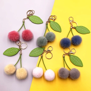 Cute cherry plush keychain with colorful faux fur balls and green leaf charms for bags