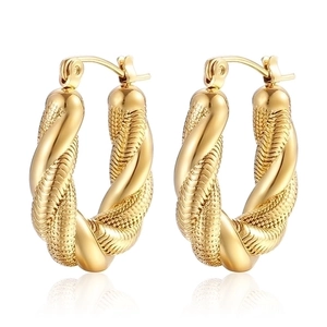 Close-up of golden twist hoop earrings with detailed braided texture and mirror reflection