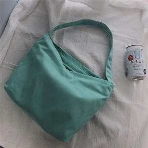 Detail view of mint green canvas tote bag featuring premium cotton fabric and sturdy straps