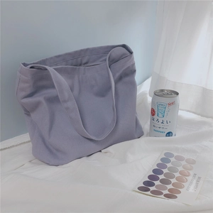 Detail of lavender canvas tote bag with clear fabric texture in a cozy setting