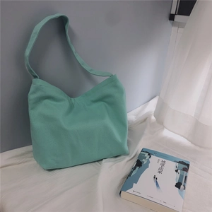Detailed view of the mint green canvas tote bag featuring premium thick fabric texture
