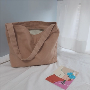 Detail view of large canvas tote bag in vintage dusty pink with top zipper and lining