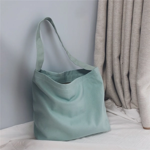 Detail view of mint green canvas tote bag shoulder strap and premium thick fabric texture