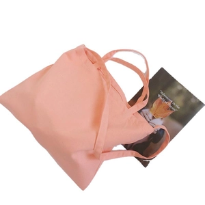Minimalist peach pink canvas tote bag with wide straps for daily commuting and shopping