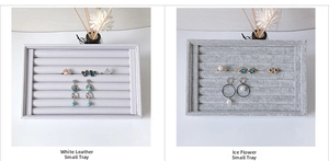 Comparison detail of white leather and grey velvet long jewelry display trays