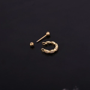 Gold U-shaped stainless steel cartilage ear clip with zircon stones on black background