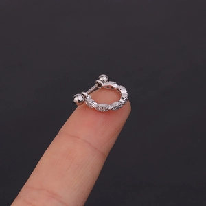 Macro shot of silver U-shaped cartilage piercing with micro-pave cubic zirconia crystals