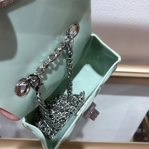 Internal view of mini PVC jelly bag showing silver chain strap and metal swivel lock