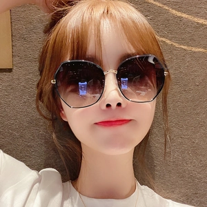 Close-up of stylish oversized round sunglasses with gradient lenses and metal frames