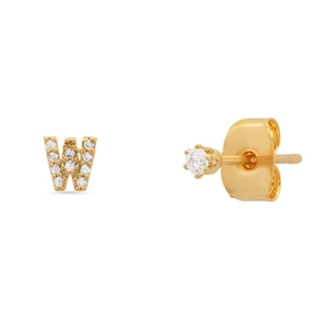 Detailed macro shot of gold S925 silver letter W earring and single diamond stud