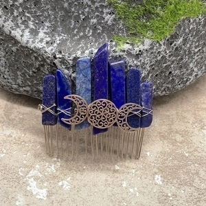 Lapis lazuli crystal hair comb with silver triple moon goddess symbol on mossy rock