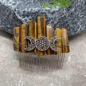 Detail of handcrafted tiger eye stone hair comb with silver crescent moon wire wrapping