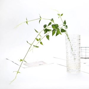 Artificial hanging clematis vine in glass vase for wedding and home decoration