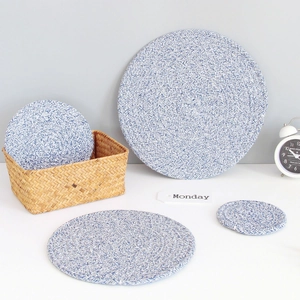 Detailed close-up of blue and white braided cotton coasters in various sizes for table decor