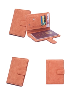 Detail view of orange RFID passport holder showing magnetic buckle and internal card slots