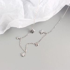 Detail of S925 sterling silver necklace featuring star and round pavé charms