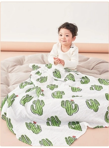 Soft cotton baby swaddle blanket with green cactus print on white background for newborns