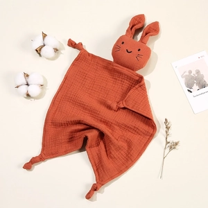 Close-up of rust red rabbit muslin comforter blanket made of soft cotton gauze fabric