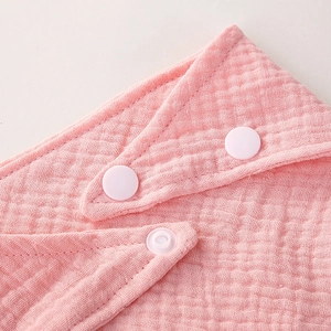 Pink double-layer muslin cotton baby bib featuring soft gauze texture and snap fasteners