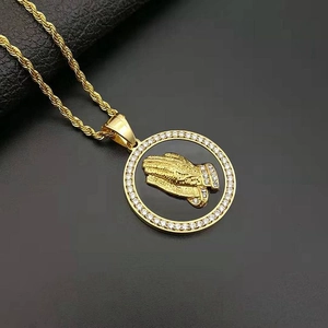 Iced out gold plated prayer hands pendant with zircons on a rope chain necklace
