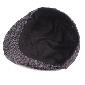 Flat lay view showing the interior lining and stitching of grey herringbone beret cap