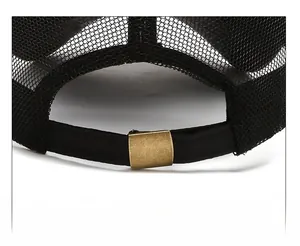 Detail of adjustable metal buckle and breathable mesh on black baseball cap