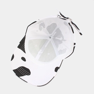 Classic cow print baseball cap featuring 100% cotton material and internal stitching