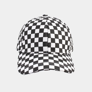 Detailed view of classic black and white checkerboard pattern on the baseball cap