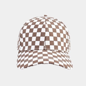 Close-up detail of the brown and white checkered canvas texture on the baseball cap