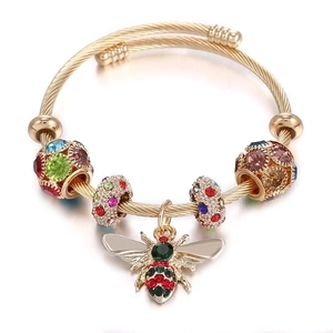 Golden titanium steel braided bracelet with colorful rhinestone beads and a bee pendant