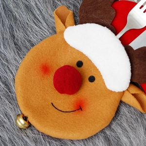 Christmas reindeer cutlery holder pouch made of felt with bells on plush background