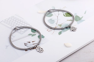 Close-up of double-layer stainless steel Hamsa Hand bracelets with Box Chain details