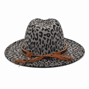 Gray leopard print fedora hat with a brown leather braided band and suede tassel detail