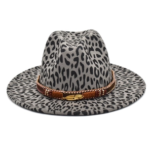 Detailed view of grey leopard fedora hat featuring woven band with golden feather charm