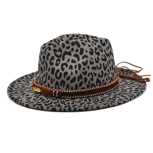 Detail of grey leopard print fedora hat featuring brown band and gold feather charm