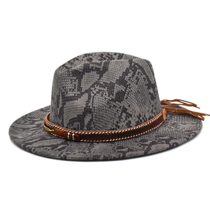 Close-up of snakeskin pattern fedora hat with ethnic style beaded band and fringe tassels