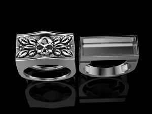 Macro detail of silver punk skull ring showing 3D embossed texture and hollow back