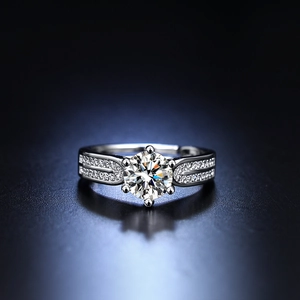 Macro view of six-prong moissanite ring with split shank and pavé set small diamonds