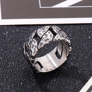 Macro view of vintage Cuban chain ring with hammered texture and oxidized finish
