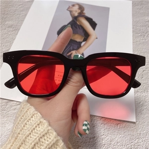 Retro square sunglasses with thick black frames and vibrant red lenses for fashion