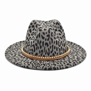 Detail of leopard print fedora hat featuring gold bead chain and braided leather band