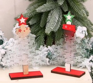 Detail view of wooden DIY Christmas trees with festive Merry and Bright typography