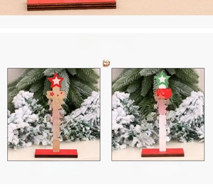 Detail of DIY wooden Christmas tree ornaments with festive greetings and snowy background