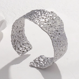 Adjustable wide stainless steel open bangle with unique hammered texture in silver finish