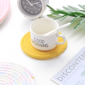Woven cotton rope coaster set with white ceramic mug on a clean minimalist desk