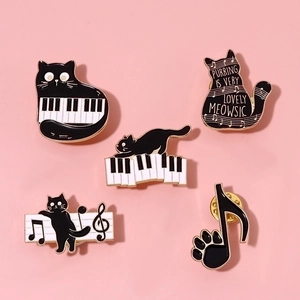 Cute black cat piano and music notes enamel brooch set on a soft pink background