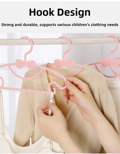 Detail of pink plastic kids hanger showing hook design for hanging camisole straps