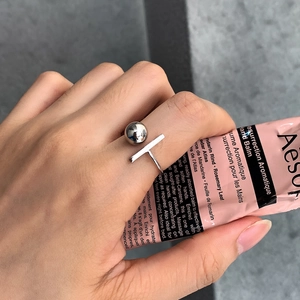 Minimalist 925 sterling silver open ring with geometric ball design worn on finger